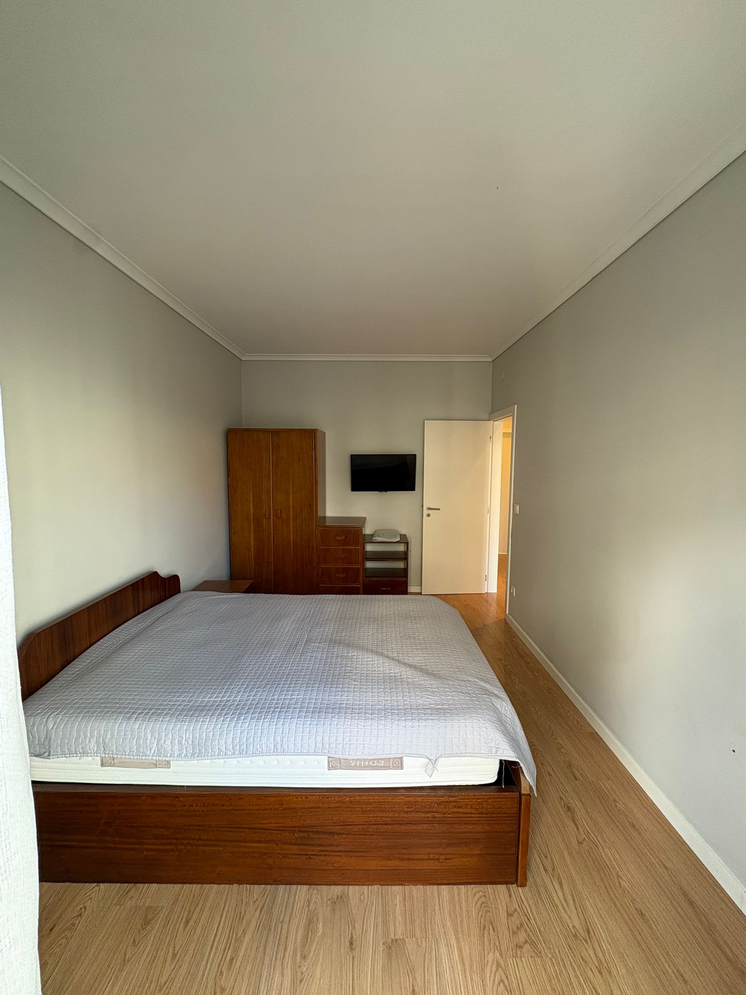 Bedroom with old wooden bed and wardrobe before MoveIn furnished it